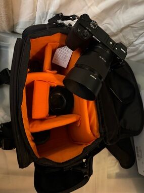 Sony Black Mirrorless Camera and Lenses in Black Carry Case with Orange Interior